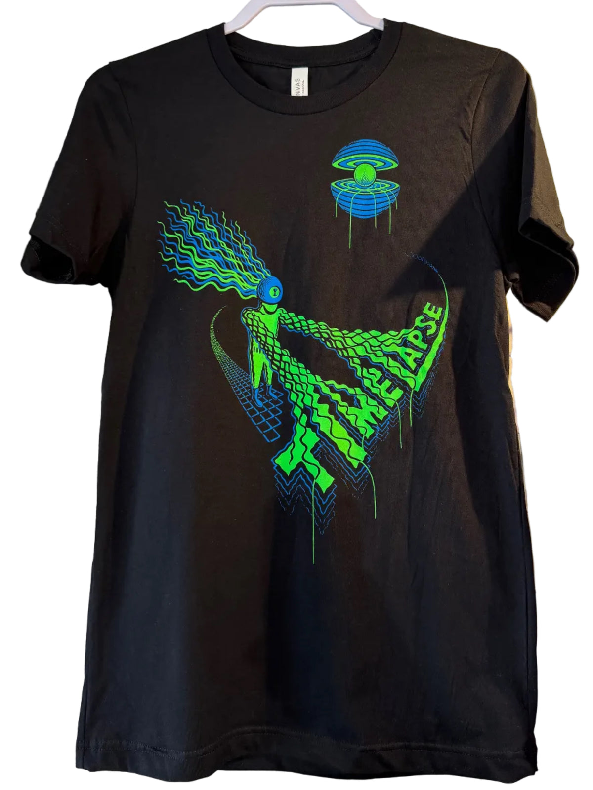 A black short-sleeve graphic T-shirt hanging on a white wire display wall. The shirt features a large neon green and blue reptile-like graphic with stylized text on the front, alongside a smaller matching blue and green emblem on the upper chest.